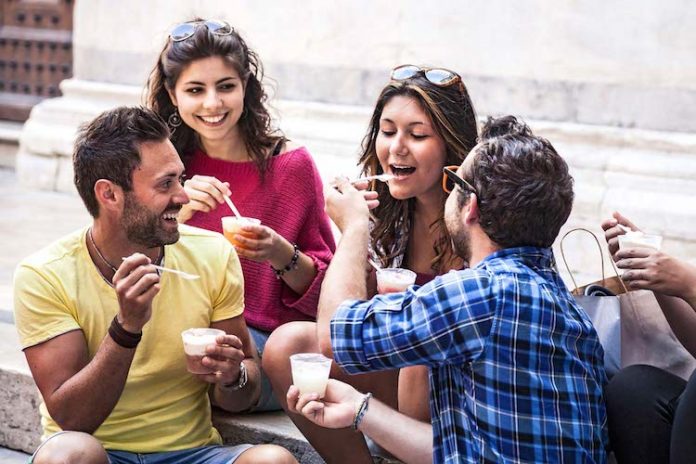 Friends taking a break outdoors eating an ice cream