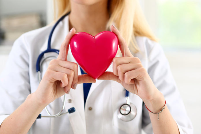 Female medicine doctor hands holding red heart