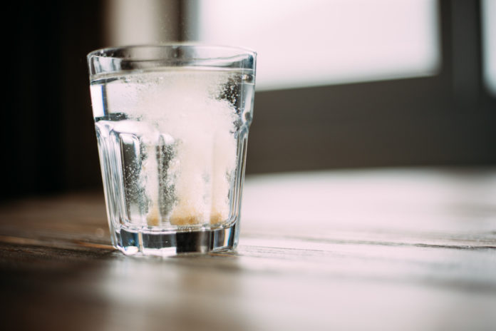 Effervescent Tablet in Water on table