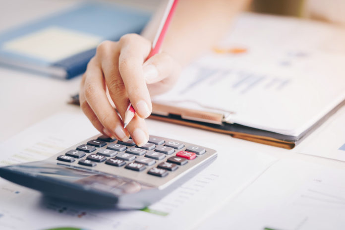 Close up of bookkeeper or financial inspector hands making report, calculating or checking balance. Investment, economy, saving money or insurance concept