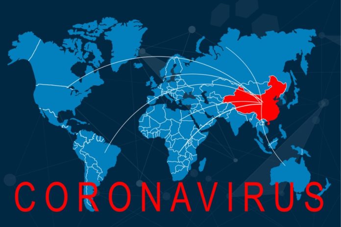 the-phrase-corona-virus-on-a-banner-with-blurred-chinese-flag-on-the-picture-id1202097133