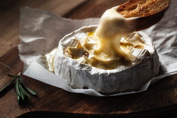 baked-camembert-with-toast-and-rosemary-picture-id544557428