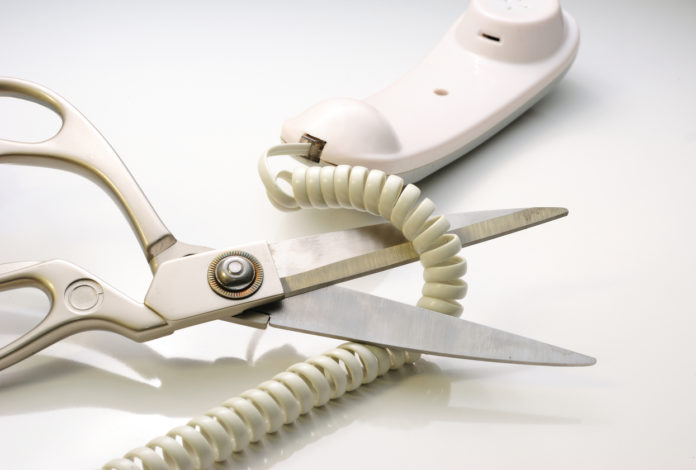 Telephone cord being cut by scissors DISTACCO DELLA LINEA