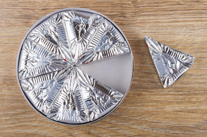 Slices of melted cheese in foil in cardboard box FORMAGGINI