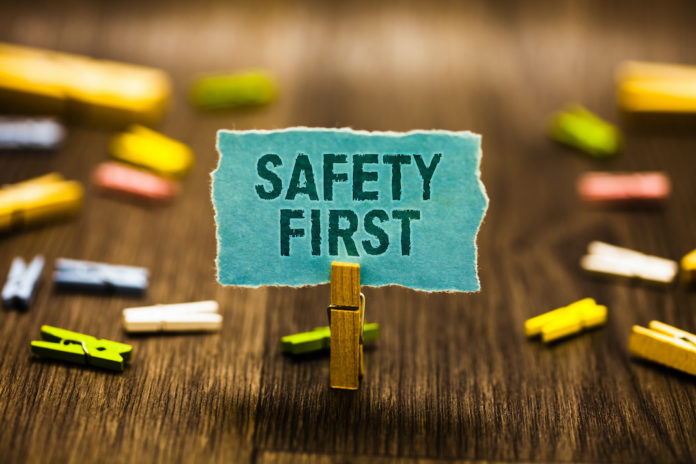Word writing text Safety First. Business concept for Avoid any unnecessary risk Live Safely Be Careful Pay attention Clothespin holding blue paper note reminder clothespins wooden floor. richiami alimentari