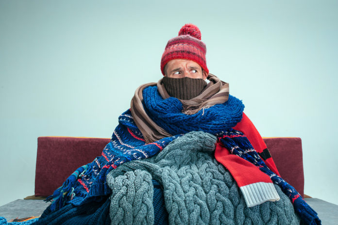 Bearded Man with Flue Sitting on Sofa at Home. Healthcare Concepts. gas