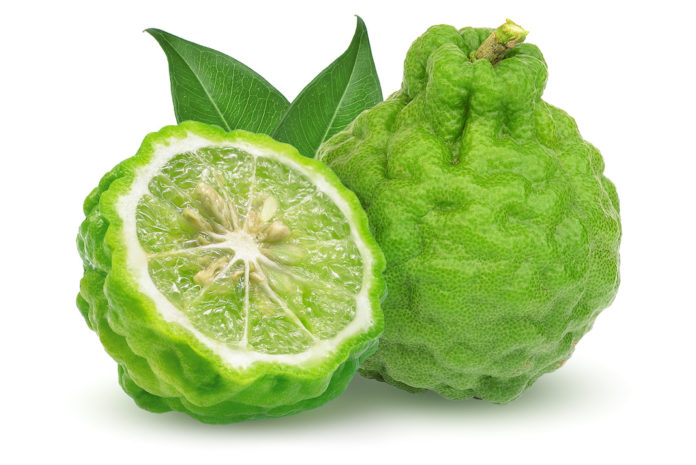 whole and half bergamot fruit with leaf isolated on white background BERGAMOTTO
