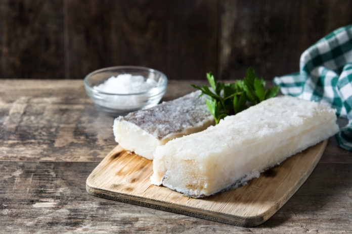 Salted dried cod on wooden table. Typical Easter food baccalà