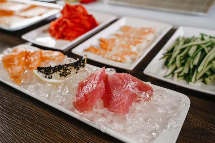 Ingredients for making sushi, arranged on plates. The view from the top crudi