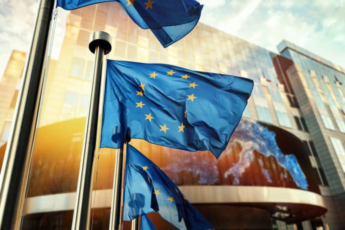 EU flags waving in front of European Parliament building. Brussels, Belgium PFAS