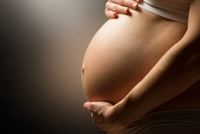 Pregnant woman belly. Pregnancy concept GLIFOSATO GRAVIDANZA DEPAKINE