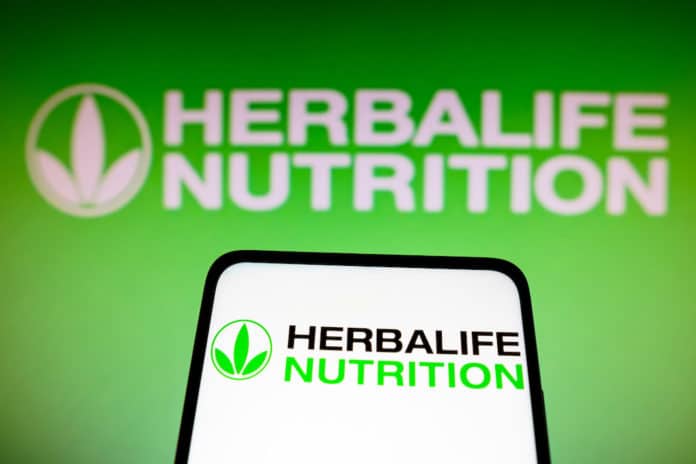 May 14, 2022, Brazil. In this photo illustration the Herbalife Nutrition logo seen displayed on a smartphone and in the background. DIMAGRIRE