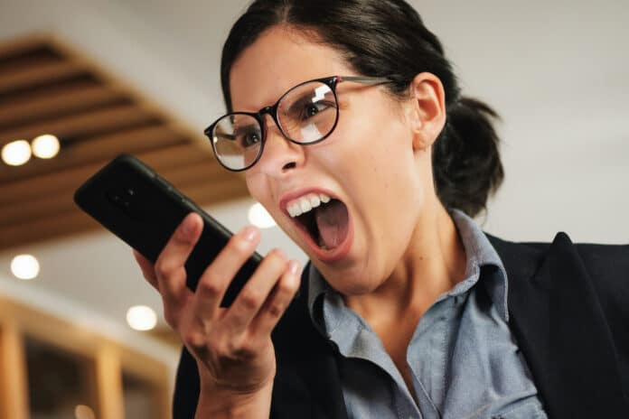 Hysterical Angry Business Woman Screaming Madly at her Smartphone TIM