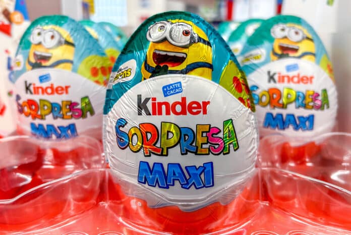 Italy - February 10, 2024: Ferrero Kinder Sorpresa Maxi easter egg packaging with Minions surprise for sale in Italian supermarket. MERENDINE