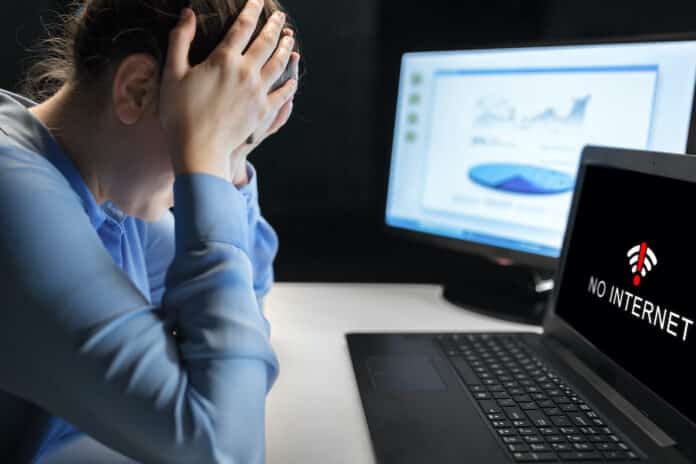 sad woman having no internet on laptop at office