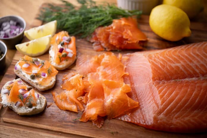 sliced cured salmon on bread with cream cheese SALMONE SELVAGGIO