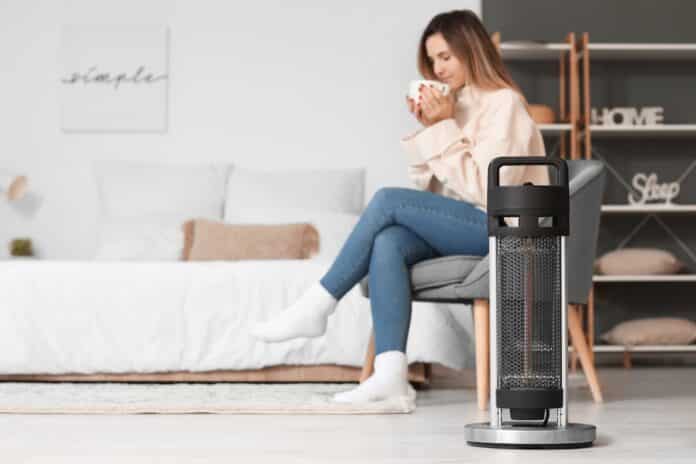 gas Modern electric heater at home of young woman. Concept of heating season gas