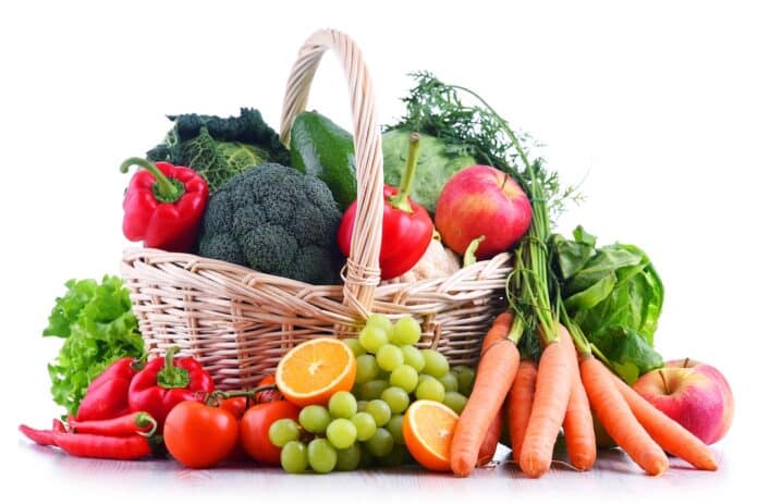 Fresh organic fruits and vegetables in wicker basket