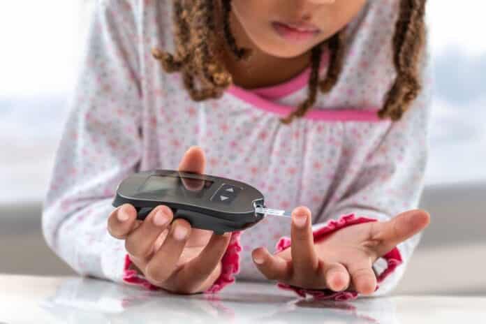 diabete Concept children diabetes children with glucometer learning to check blood sugar level at home. Learn to use a glucometer diabete