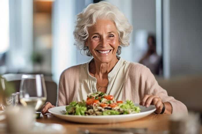 old woman and salad dish or vegetable food on the table ANZIANI DIETA