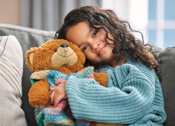 Portrait, hug or child with teddy bear for love, comfort and toy for support, therapy healing or play. Mexican girl, orphan and stuffed animal in home with happiness, kid and donation gift for game GIOCATTOLI PFAS