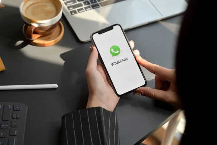 CHIANG MAI, THAILAND - FEBRUARY 1, 2020 : female holding iPhone with WhatsApp screen. WhatsApp is messaging application GHOSTPAIRING
