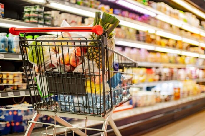 A shopping cart with grocery products in a supermarket gdo