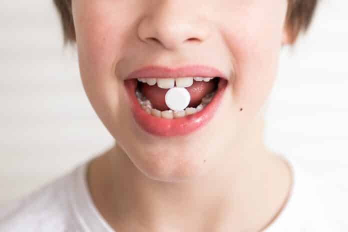 Vitamins and supplements pills for kids. Medicine concept. Toddler boy eating pills and supplement vitamins for better immunity. Child taking medicines pills. Medical concept. FARMACI CHALLANGE