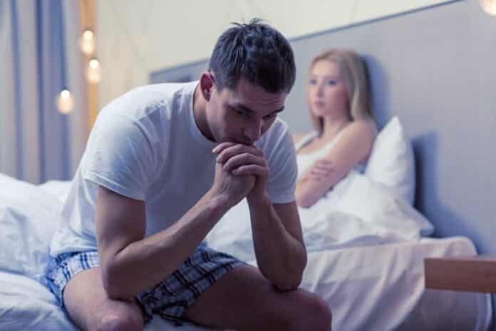 man sitting on the bed with woman on the back FINASTERIDE