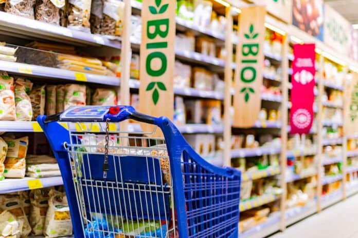 A shopping cart with grocery products in a supermarket BIOLOGICO