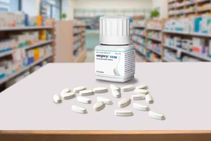 Medicine container bottle with weight-loss drug Wegovy tablet pills from Novo Nordisk inside a blurred pharmacy. Copenhagen, Denmark - January 28, 2026 WEGOVY ORALE